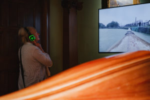 Audience member watching the Ghost film wearing headphones